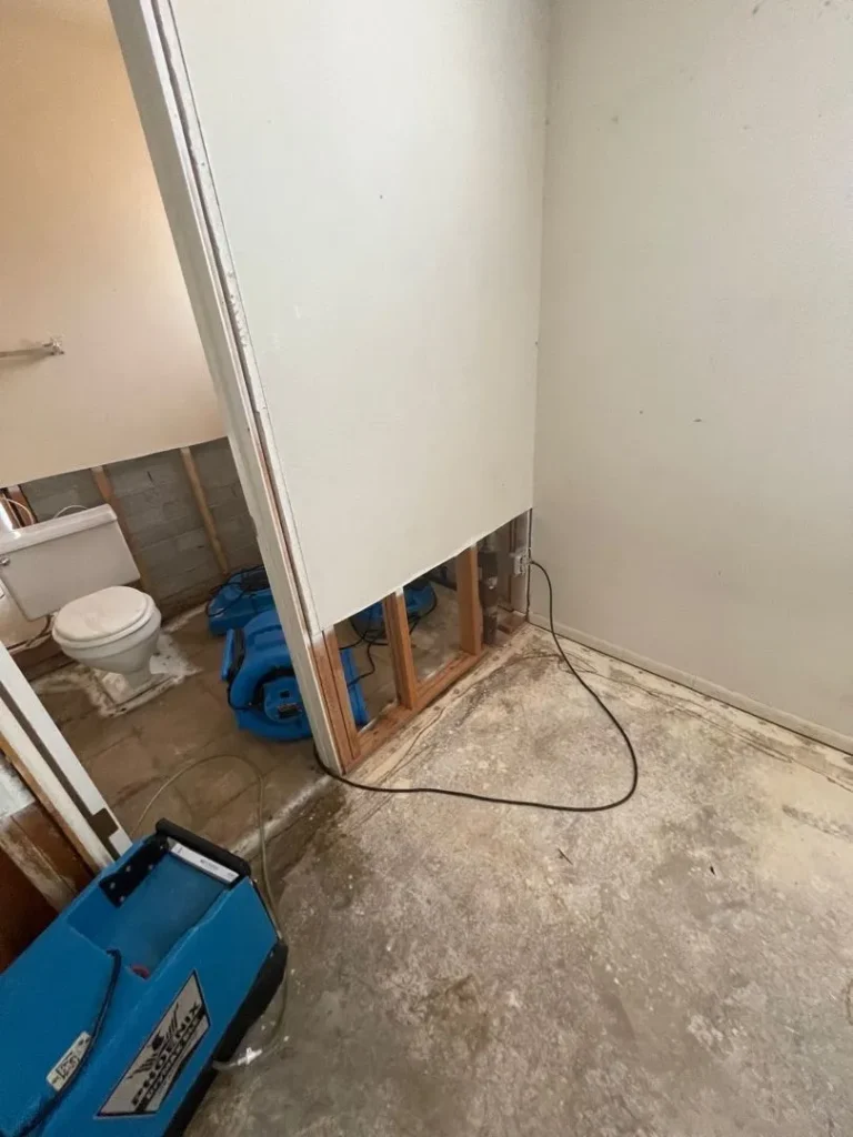 bathroom wall cut open for water damage drying